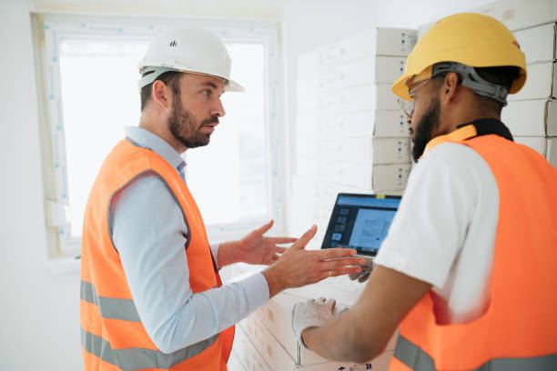 istock Architect and contractor consulting project on laptop at construction site 2187612317