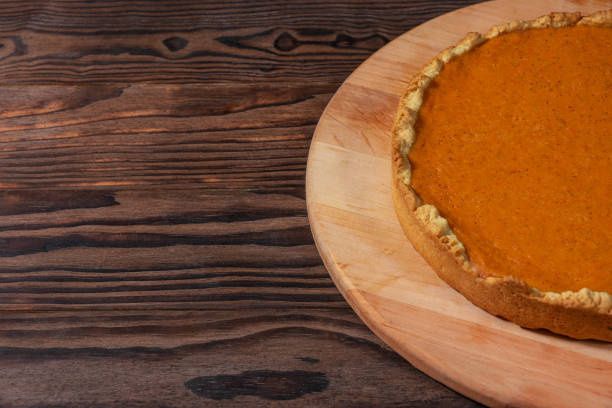 istock Homemade Pumpkin Pie on Rustic Wooden Background 2187613439