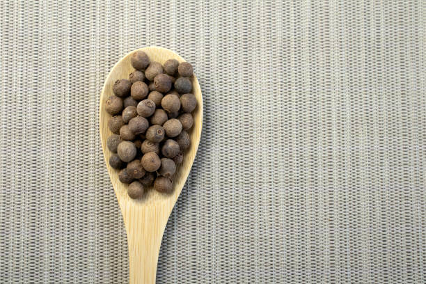 Jamaica pepper, traditional spices. allspice close-up. selective focus Spices, allspice on textile background macroshoot