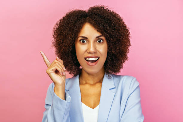 istock Excited Woman Pointing finger up On Pink background 2187614534