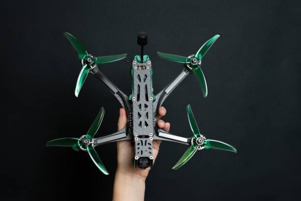 istock Professional modern drone with digital camera in hand on black background 2187614766