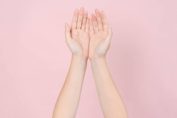 istock Manicured nails, beautiful woman hands forming an elegant shape on pink background 2187614842