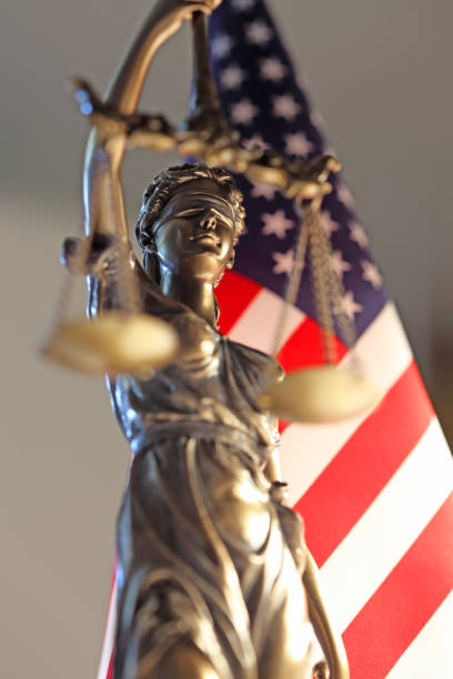 scales of justice made of wood, symbolizing justice and law. lawyer robe in the background