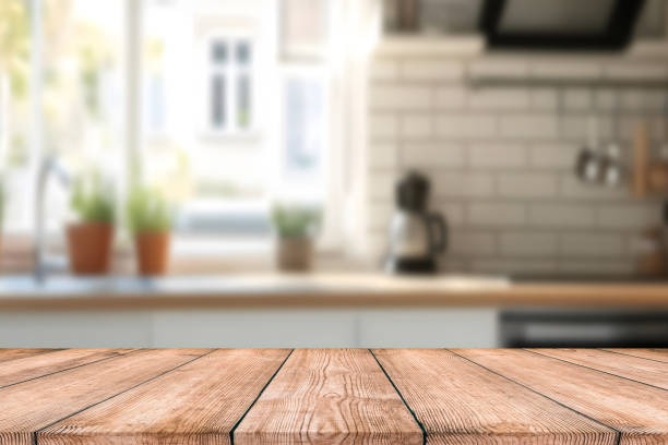 istock Empty Beautiful wood table top and blur bokeh modern kitchen interior background in clean and bright, Ready for product montage 2187623739