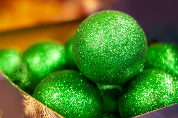 Close-up of Christmas and New Year green balls on a blurred background
