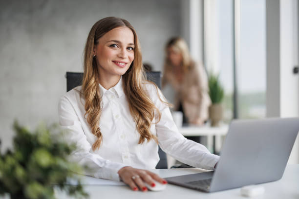 istock Confident Businesswoman Smiling While Working in Modern Office Setting 2187628352