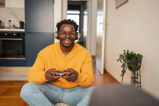 istock Smiling young man enjoying a gaming session with headphones 2187642488