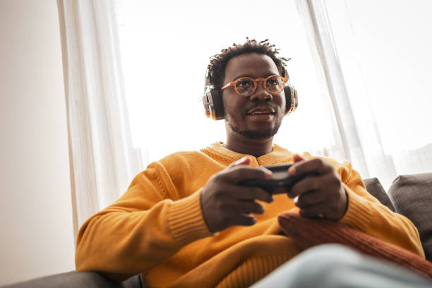 istock Young man enjoying a video game with headphones on 2187642509