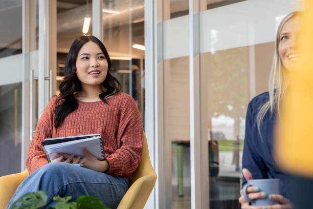 istock A sales team discusses quarterly targets during a meeting. 2187643301