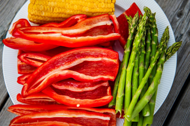 vegetables prepared for grill. Paprika, corn cob, asparagus for grill.