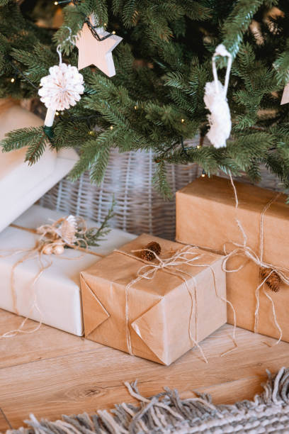 istock Beautifully wrapped gifts under a Christmas tree with decorative ornaments 2187644145