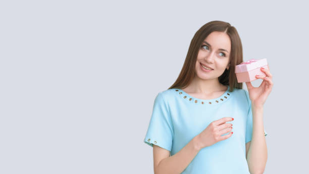 istock Present party holiday surprise curious happy woman 2187644418