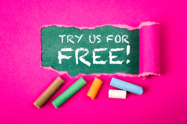 istock Try Us For Free. Text under torn purple paper on a green chalkboard 2187645466