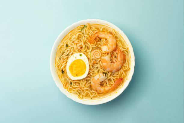 istock Spicy instant noodle with shrimp and egg on a blue background top view 2187646413