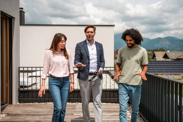 istock Multiracial Team Discusses 3D Renovation Plans on Tablet Outdoors 2187646471