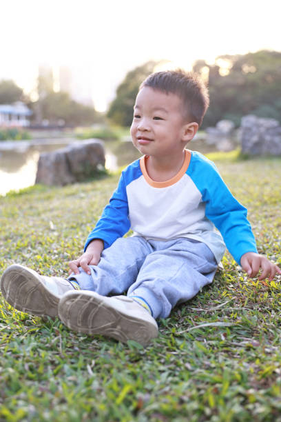 istock Cute children playing in the park 2187648173