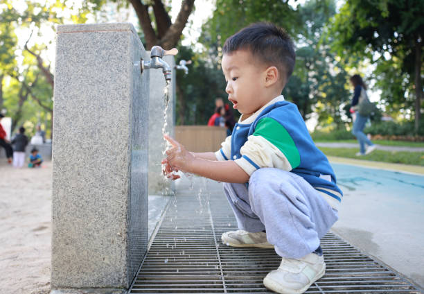 istock Little child washing hands and drinking water 2187649713