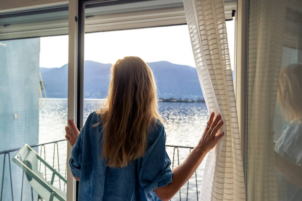 istock Woman discovers beautiful sunrise on the lake 2187650183