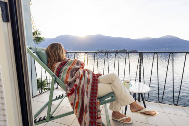 istock Woman Relaxing on Balcony Overlooking Scenic Lake View 2187650232