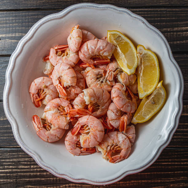 istock Tiger king prawns cooked and seasoned with lemon, close up top view 2187654404