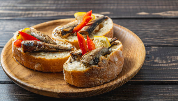 istock fish sandwich with butter and sprats lemon and red pepper 2187654481