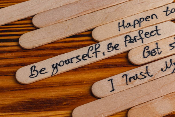 istock Positive thoughts for increasing selfesteem on wooden posts on wooden background 2187654500