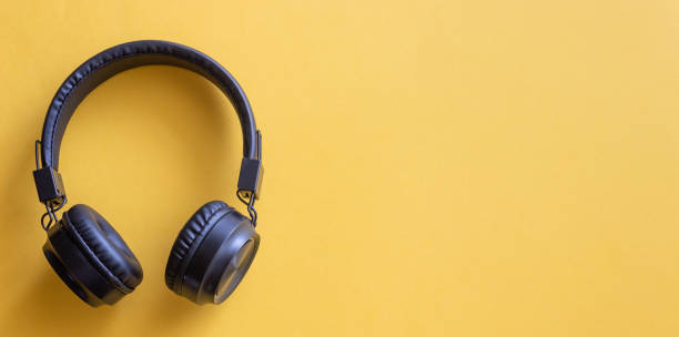 istock Black headphones on a yellow background. Minimal concept. Mock-up. Music. 2187659049