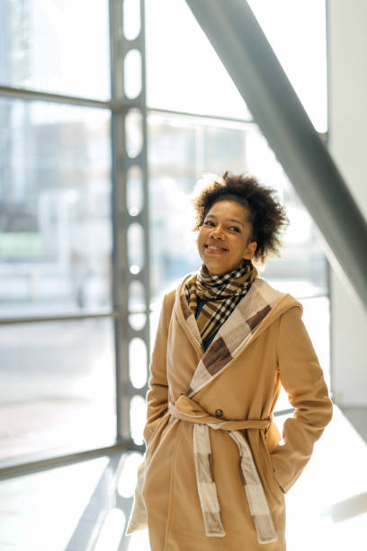 istock African American walking through office building glass corridor 2187659433