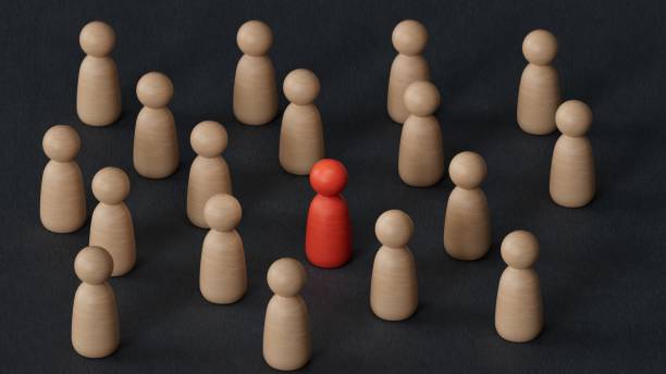 istock Discrimination and inclusion concept. The wooden figurines surrounded the red one.3D rendering on black background. 2187659514