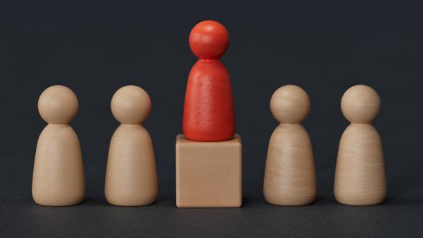 istock Wooden person model among people, Leadership concept.3D rendering on black background. 2187659643