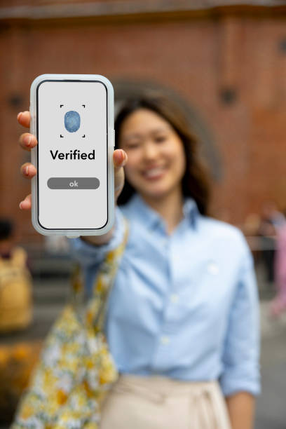 istock Woman holding up digital verification screen 2187659938