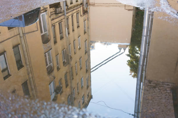 istock Reflection of a building in a puddle 2187660661