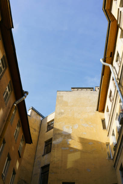 istock Building with a yellow facade and a blue sky above it 2187660667