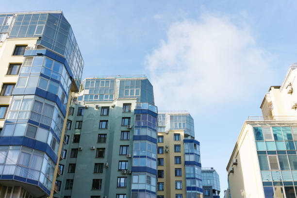 istock Row of tall buildings with blue windows and a clear blue sky 2187660688