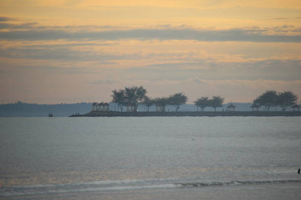 istock reddish orange sunrise on the morning beach 2187661425