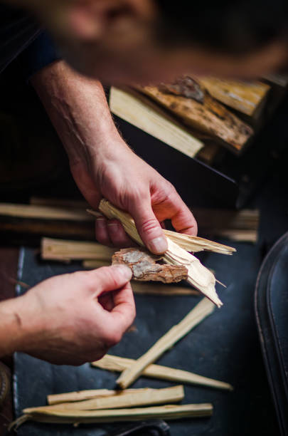 istock male Preparing kindling for fire with hands holding bark and wood pieces 2187663348