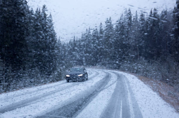 istock Car and snow on road 2187664102