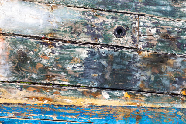 pattern of old rotten wooden planks at an old ship in harmonic aging structure