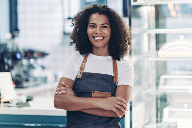 istock Smiling young barista standing at the counter 2187666989