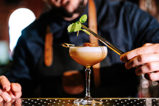 Close-up of a bartender garnishing a Daiquiri cocktail in the pub stock photo