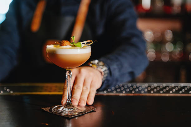 istock Close-up of a bartender's hand serving a Daiquiri 2187667227