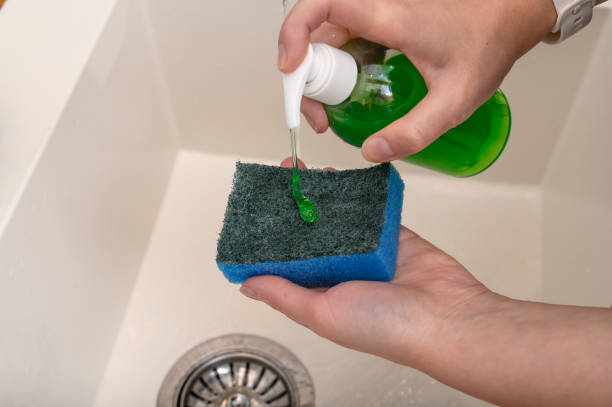 istock Detergent green dishwashing liquid dosed on a kitchen sponge 2187668368
