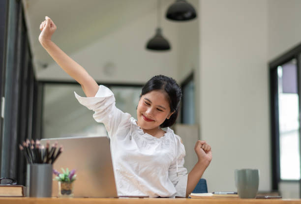 istock Female office worker stretching lazy at the desk to relax while working in the office. 2187668878
