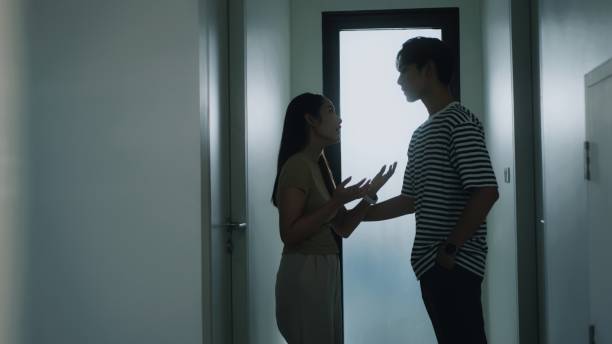 istock Asian Couple Arguing in a Silhouetted Scene Inside a Modern at home 2187668930