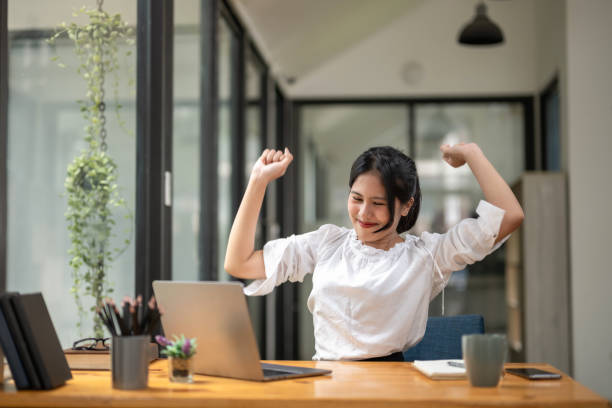 istock Female office worker stretching lazy at the desk to relax while working in the office. 2187669034