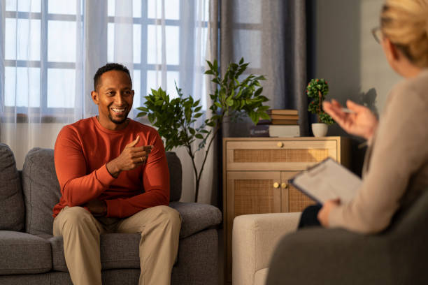 istock Man listening attentively, engaging in a thoughtful conversation on a grey sofa setting. 2187671213