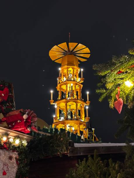 Christmas decoration of the square in Dresden. Wooden toys, spruce branches and Christmas tree decorations. Festive atmosphere. Evening, Christmas lighting, garlands.
