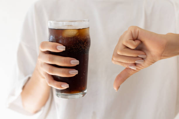 istock Woman holding a coke 2187672918