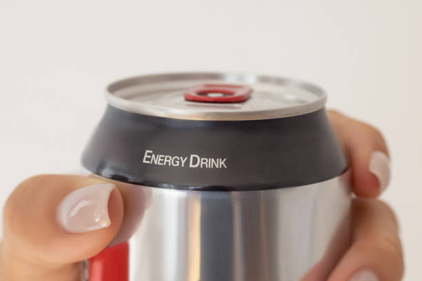 Unrecognisable person holding energy drink against white background