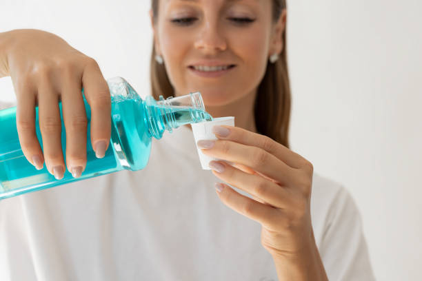 istock Woman pouring mouthwash into cap 2187673242